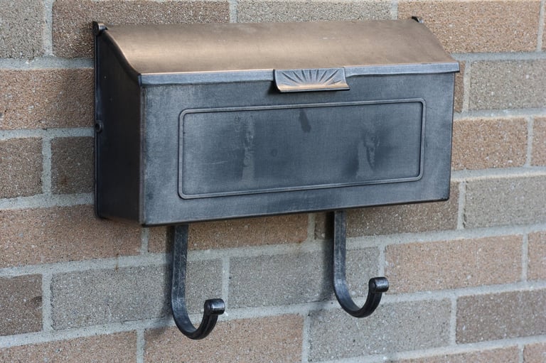 Restored black mailbox with clean hardware and fresh finish after professional refurbishment